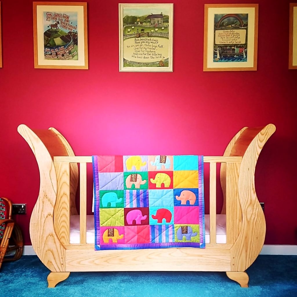 A sleigh bed cot