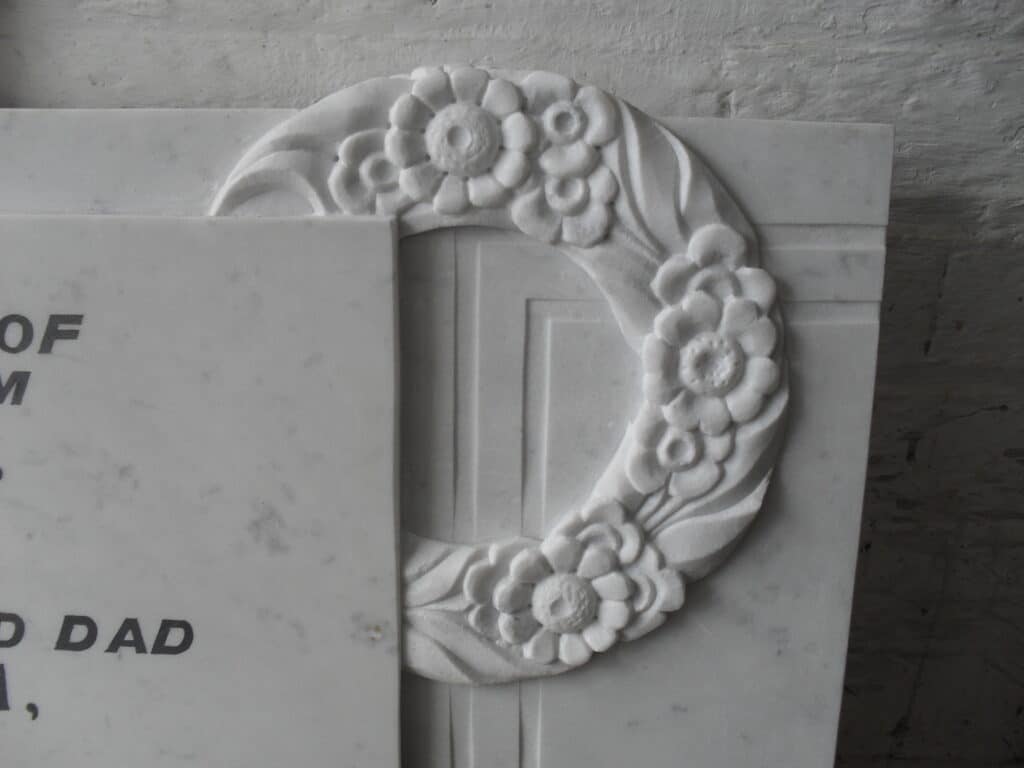 Marble carved memorial with flush lead lettering