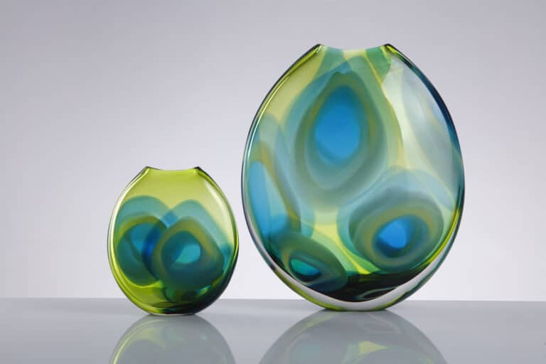 Tondo Vases Made by Allister Malcolm Glass Limited Seamlessly blending form and function, through fluid contours and delicate craftsmanship. Each piece invites you to immerse yourself in an enchanting world of colour and light.  Available in 3 sizes small 16cm, medium 30cm and large 38cm tall and in 5 differing colour combinations.  Tondo comes from the Italian word “rotunda” which means round. Its been embraced as a renaissance term for a circular work of art