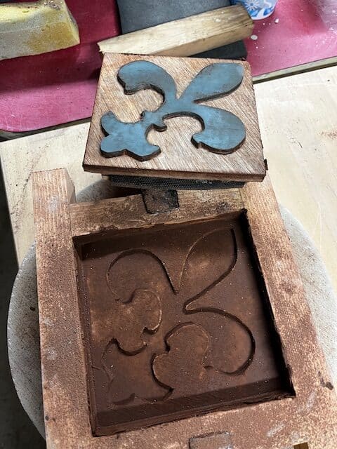 Mould stamped into soft earthenware clay in retaining mould