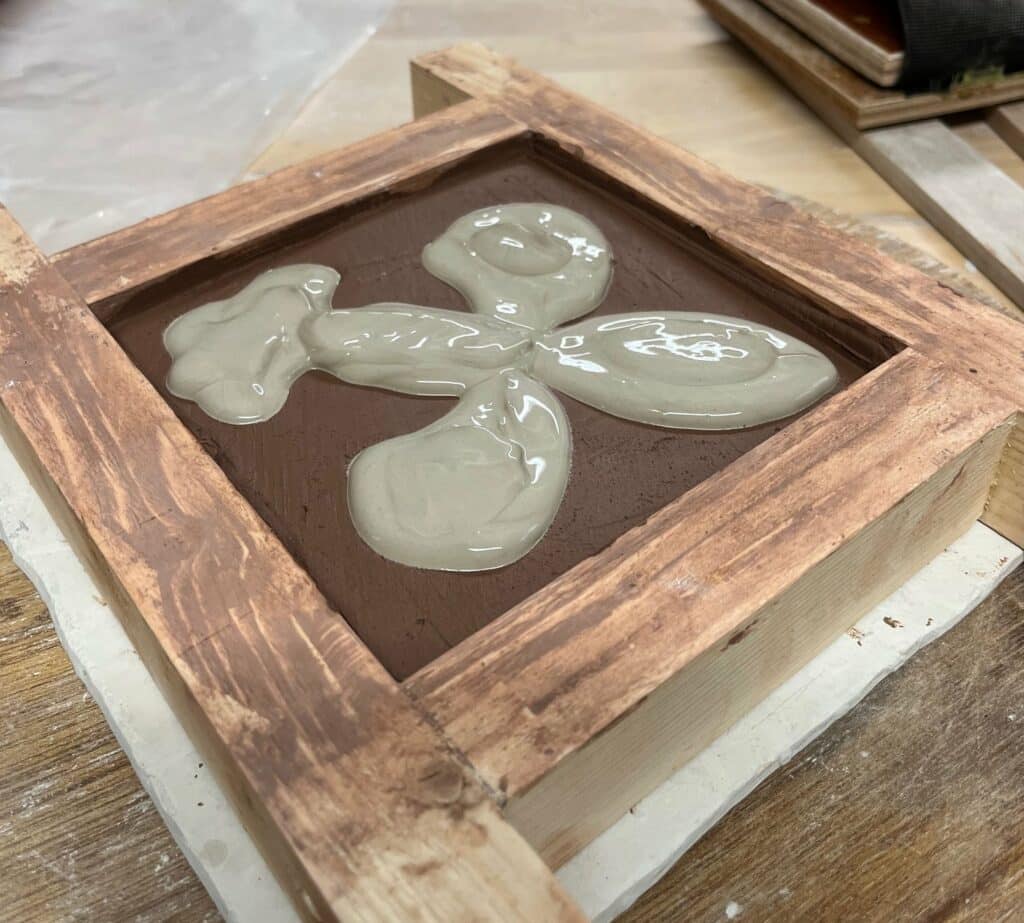 Stamped recesses filled with white clay slip