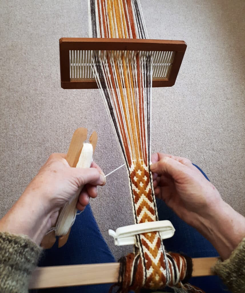 Inkle Weaving on a backstrap loom, using hand-spun and natural dyed locally sourced wool